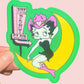 Sticker of a betty boop on a moon with 'Pink Pony Club' sign, held against a pink background.