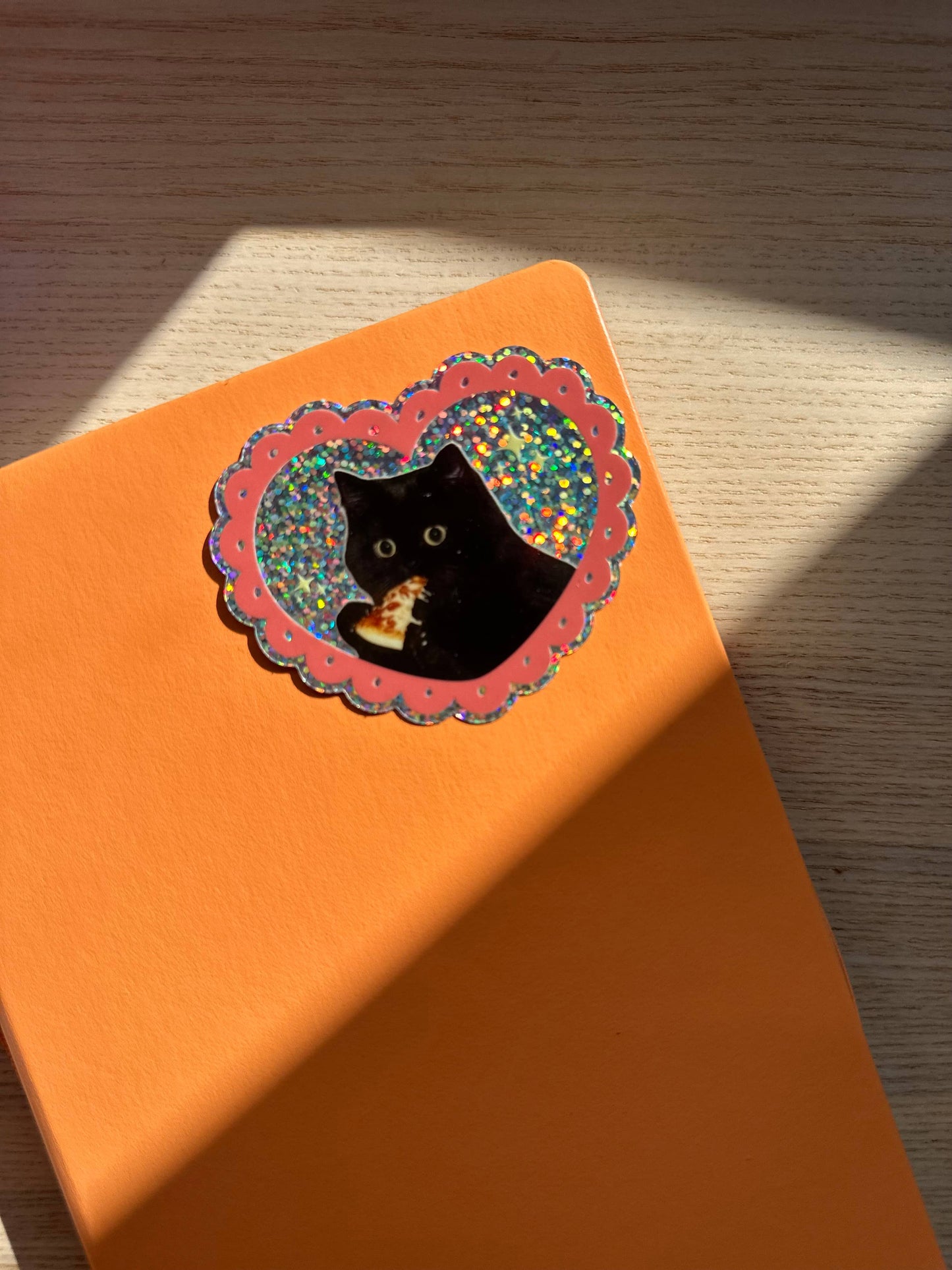 pizza cat glitter sticker on an orange background