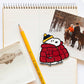 Magnet of snoopy in a red coat with a yellow pencil on a notebook