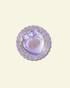 Purple Polly Pocket toy sticker on a decorative purple and glitter circular base with a light beige background