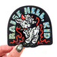 Sticker with a goat and text 'Raise Hell, Kid' held by a hand.
