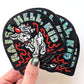 Stack of 'Raise Hell, Kid' stickers held by a hand with a white background