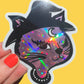 Holographic cat sticker held by a hand with red nail polish on a yellow background