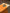 Orange notebook with a colorful sticker of a hamster on a wooden surface