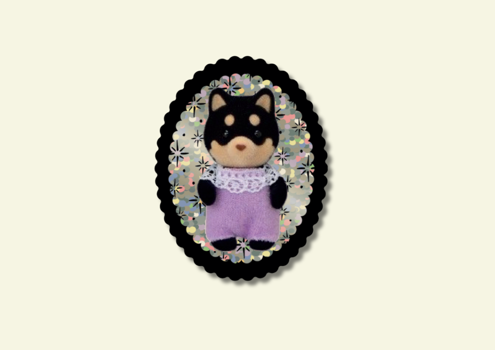Small dog figurine in a decorative frame on a beige background