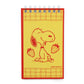 Notebook with a red border featuring a cartoon dog holding strawberries on a yellow background.