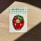 Shellflower glitter sticker on a wooden surface