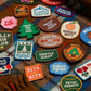 Collection of various dog-themed patches on a plaid fabric background