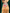 Dog wearing a checkered bandana with a heart-shaped 'Best Buddy' sign against a green curtain background