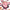 Pink cake-shaped sticker with cherries held by a hand against a blurred background