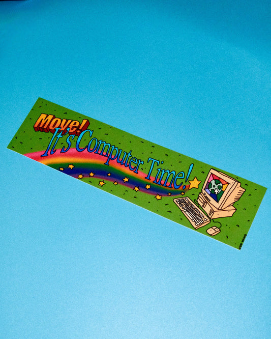 A rectangular green bumper sticker with the text 'Move! It's Computer Time!' in stylized lettering, featuring a cartoon computer, keyboard, mouse, rainbow, and stars, shown on a solid blue background.