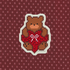 Pixelated bear with red heart and bow on a patterned background