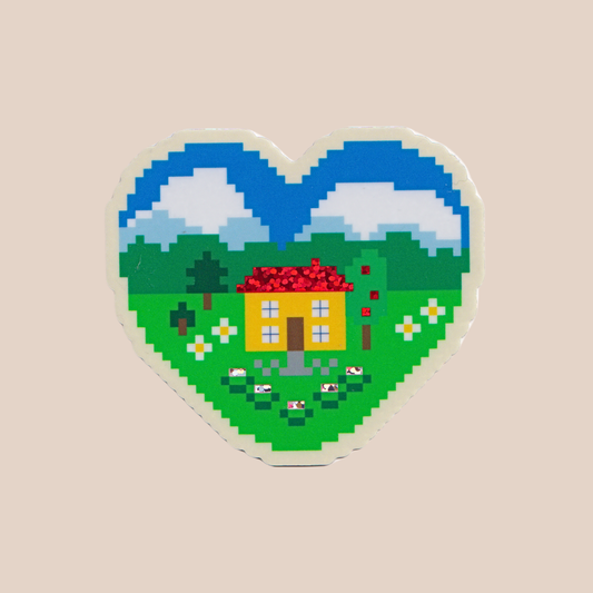 Heart-shaped pixel art sticker with a house and landscape on a beige background