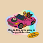 A die-cut holographic sticker featuring a pink convertible car with two women driving, plus the text 'Hop in diva, we're going to be gay & do crime.' and a yellow 'WOW! Holographic' badge, shown on a beige background.