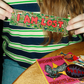 Person holding a colorful 'I AM LOST' sticker