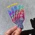 Colorful glittery lava lap sticker held by a hand on a gray background with &