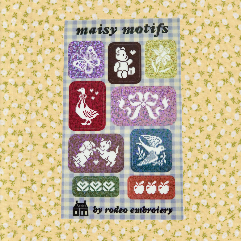 Packaging of 'maisy motifs' by rodeo embroidery on a floral background