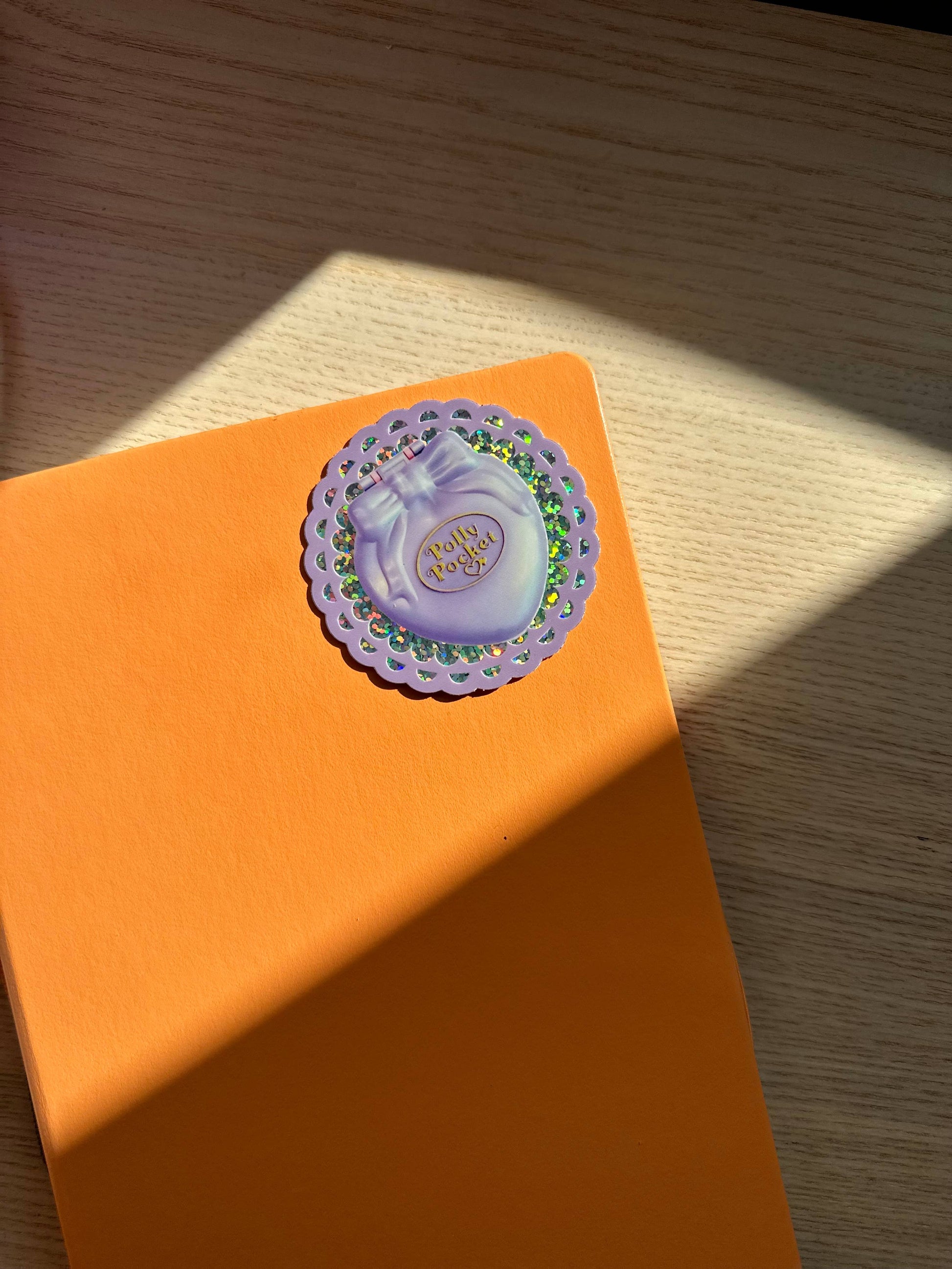 Polly pocket sticker on an orange background