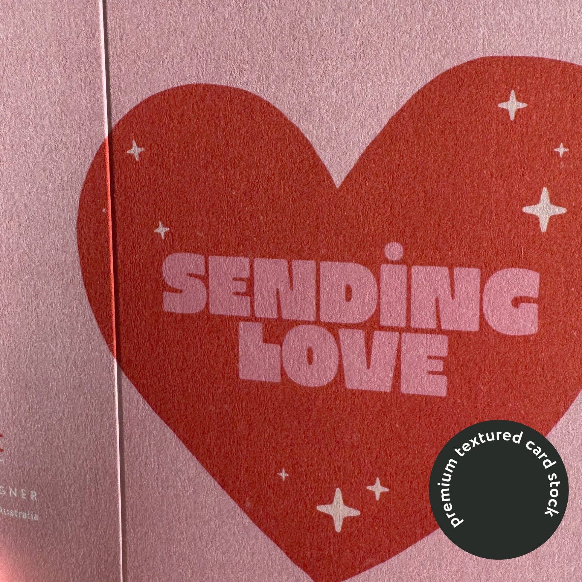 Heart-shaped card with 'Sending Love' text on a pink background