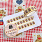 Washi tape with teddy bear design on a checkered fabric background