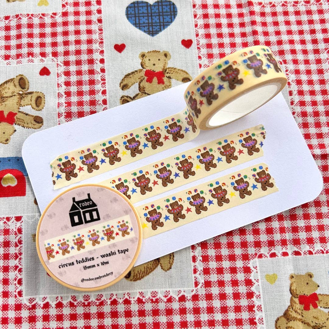 Washi tape with teddy bear design on a checkered fabric background