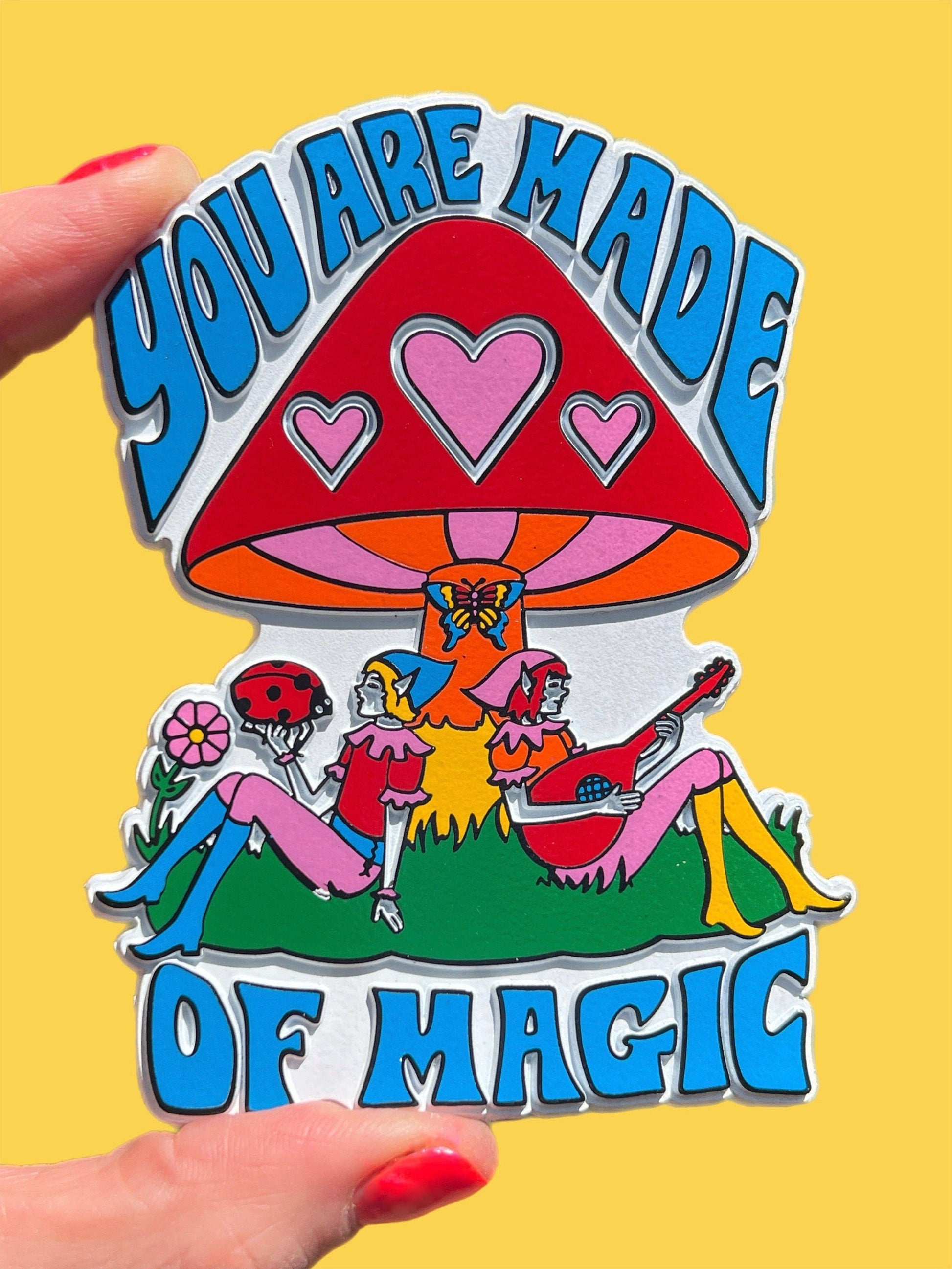 Colorful magnet with mushroom design and 'You are made of magic' text on a yellow background